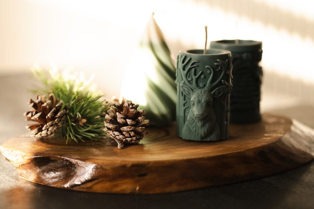 a-couple-of-candles-sitting-on-top-of-a-wooden-table-swl3fuznu8c
